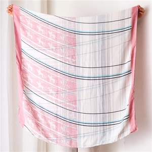 Detail of equestrian horse print on soft light pink and white scarf shawl wrap