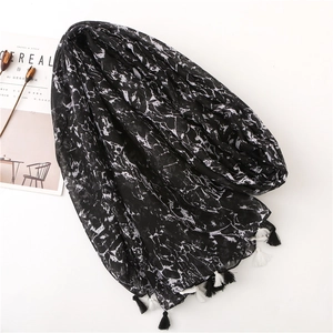 Linen cotton scarf with black and white marble print and tassel edges on white background