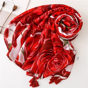 Red cotton linen scarf with large rose prints and decorative tassels on white background