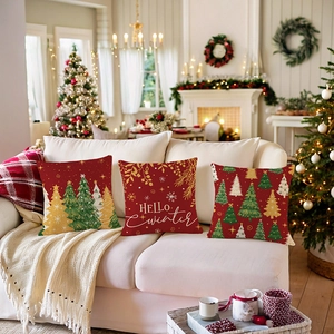 Three red Christmas pillow covers with festive tree patterns and HELLO Winter text