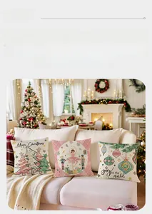 Detail of Christmas pillow covers featuring nutcracker and tree prints on a white sofa