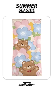 Close-up of beach towel showing two cartoon bears and colorful floral prints on fabric