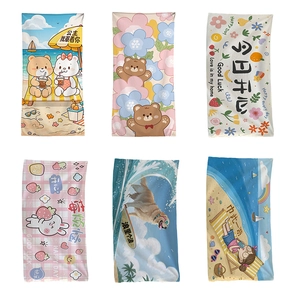 Detail view of six colorful cartoon printed beach towels with various cute patterns