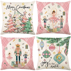 Set of 4 Christmas throw pillow covers with nutcracker and tree patterns in soft pink hues