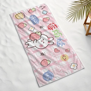 Pink checkered beach towel with cute bunny and strawberry design on white sand surface