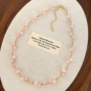 Detail of pink natural stone beaded double-layer necklace with gold-plated lobster clasp