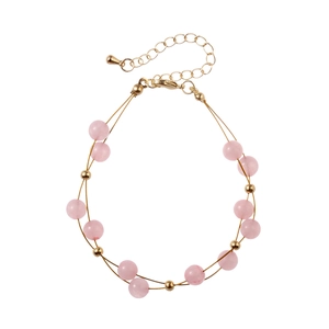 Detail of pink natural stone double-layer bracelet with gold beads and adjustable chain