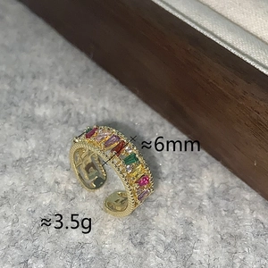Macro detail of 6mm multi-colored baguette-cut zircon open ring with gold plating