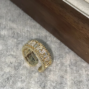 Detail of vintage gold open ring featuring emerald-cut cubic zirconia and milgrain edges