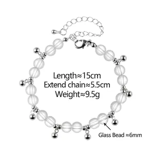 Handmade clear glass bead bracelet with silver metal charms and lobster clasp closure