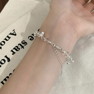 Minimalist transparent beaded bracelet with silver metal beads on a female wrist