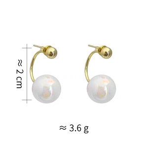Detail shot of mermaid pearl earrings with gold hooks and iridescent white beads