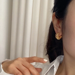 Elegant gold twisted hoop earrings for women with fine textured woven metal design