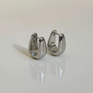 Polished silver U-shaped huggie earrings with a modern minimalist teardrop silhouette