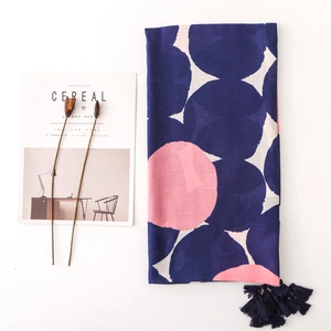 Navy blue and pink polka dot cotton linen scarf with tassels on white background