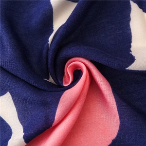 Macro shot of striped cotton-linen scarf fabric showing navy pink textures and weave