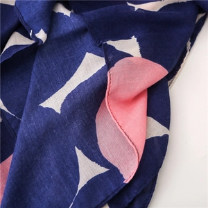 Detailed macro view of navy blue polka dot scarf with fine weave and hemmed edges