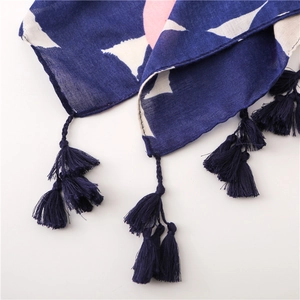 Detail of navy blue cotton-linen scarf fabric with pink dots and hand-woven tassels