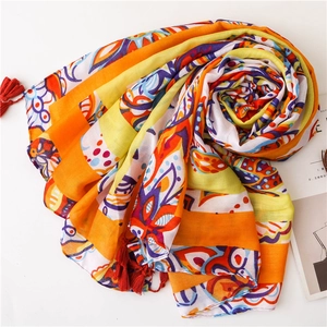 Colorful Bohemian style scarf with geometric patterns and red fringe tassels on white