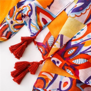 Detail of bohemian floral print scarf with soft tassels and vibrant ethnic patterns