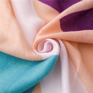 Detail of colorful striped cotton linen shawl with soft fringe and ethnic bohemian pattern