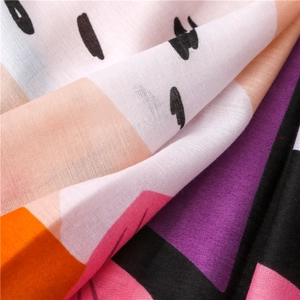 Macro detail of breathable cotton linen scarf fabric with bohemian multi-color floral print