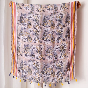 Detail view of pink bohemian paisley scarf featuring intricate gold foil and fringe