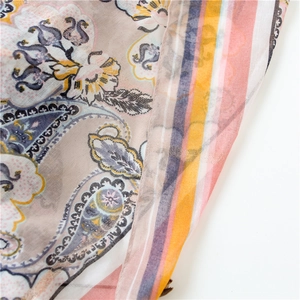 Macro detail of Bohemian paisley cotton linen scarf showing soft texture and gold stamping