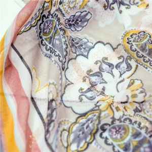 Detail of bohemian paisley cotton linen shawl with shimmering gold lurex thread weave