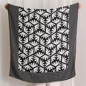 Detailed close-up of breathable black and white polka dot floral pattern long scarf texture