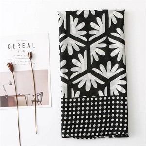 Modern black and white floral scarf with polka dot trim and abstract geometric pattern