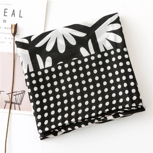 Detail of floral and polka dot print on lightweight black and white summer scarf