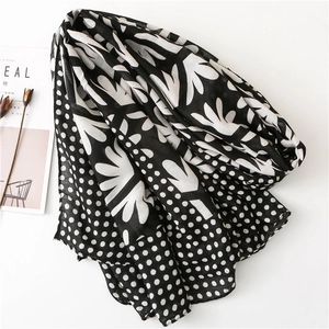 Long black and white scarf featuring abstract leaf patterns and polka dots for women