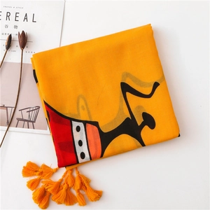 Detailed view of orange cotton linen scarf with ethnic patterns and fringe edges