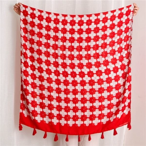 Red floral print scarf with fringe tassels being held open for full size display