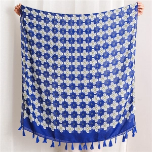 Royal blue floral shawl with white flower print and decorative blue fringe tassels