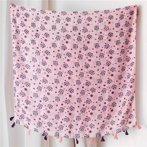 Detailed view of pink linen scarf featuring owl prints and handmade tassels for women