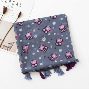 Detail of owl print scarf with dual-tone tassels and soft cotton-linen texture