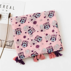 Detail of pink owl print scarf with handcrafted tassels and lightweight linen texture