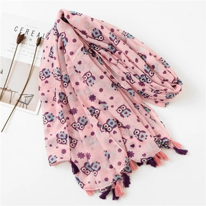 Close-up of pink linen scarf with cartoon owl prints and bicolour handmade tassels