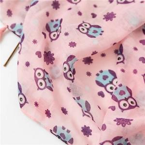 Close-up of lightweight cotton linen scarf with owl floral prints and pink tassels