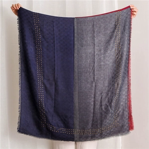 Detail of color-block scarf with golden studs and subtle checkerboard pattern