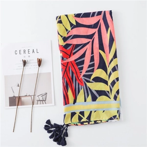 Floral cotton linen scarf with tropical leaf print and blue tassels for summer beach sun protection