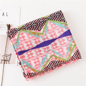 Close-up of geometric print scarf with frayed edges and pastel colored patterns