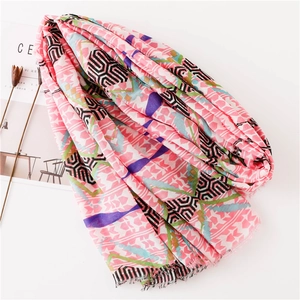 Pink geometric pattern silk scarf with fringe trim and maze print for beach sun protection