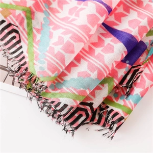 Detailed macro view of lightweight fabric texture and colorful fringe on the summer scarf