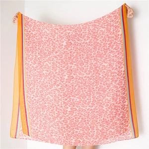 Close-up of lightweight pink leopard print scarf with colorful striped border edges