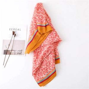 Detail of pleated pink leopard print scarf with colorful stripes and soft texture