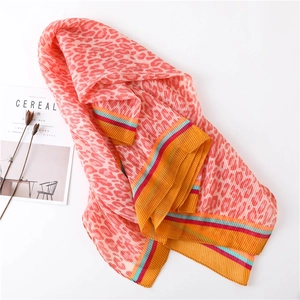 Pink leopard print pleated scarf with colorful striped edges on a white background