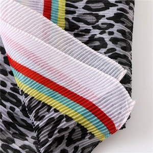 Detailed view of pleated leopard print scarf with colorful striped edge texture